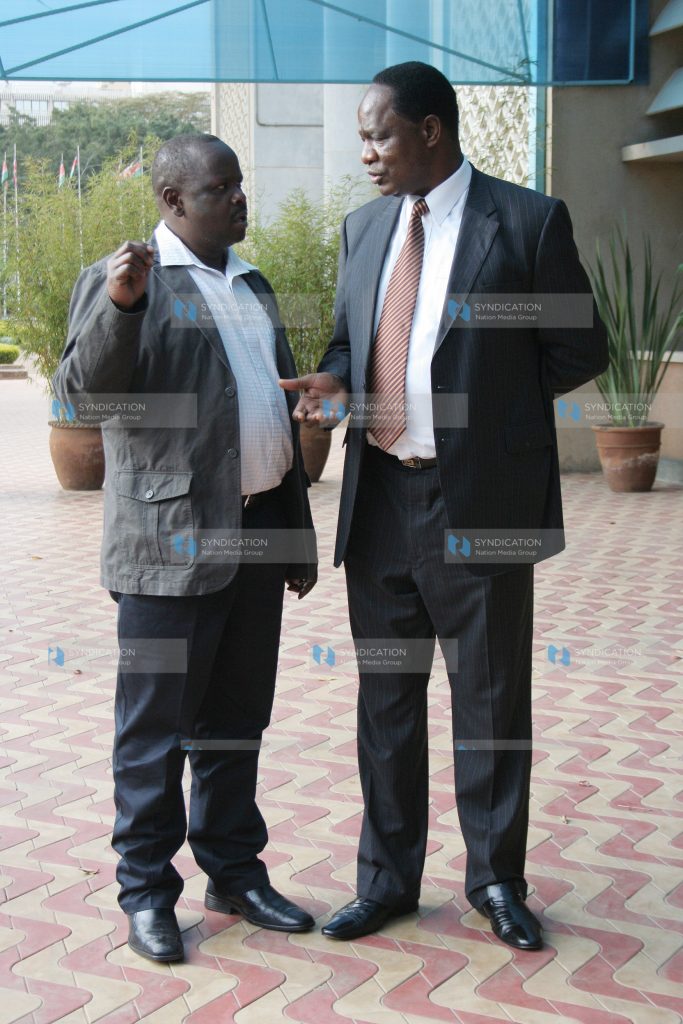 Public Service Minister Dalmas Otieno chats with Chepalungu MP Isaac Ruto