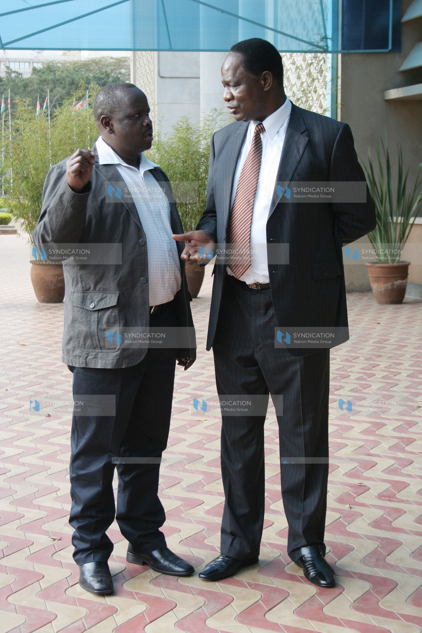 Public Service Minister Dalmas Otieno chats with Chepalungu MP Isaac Ruto