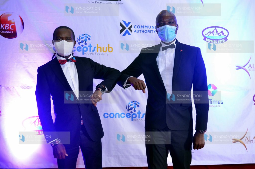 Kenya Film Commission CEO Timothy Owase greets Ministry of Information and Technology (ICT) CS Joe Mucheru