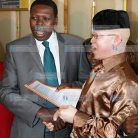 Justice Minister Eugene Wamalwa receives a petition from Isaac Mwaura