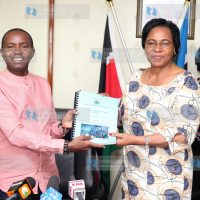 Public Service and Gender Cabinet Secretary Margaret Kobia hands over the youth report to ICT Cabinet Secretary Joe Mucheru