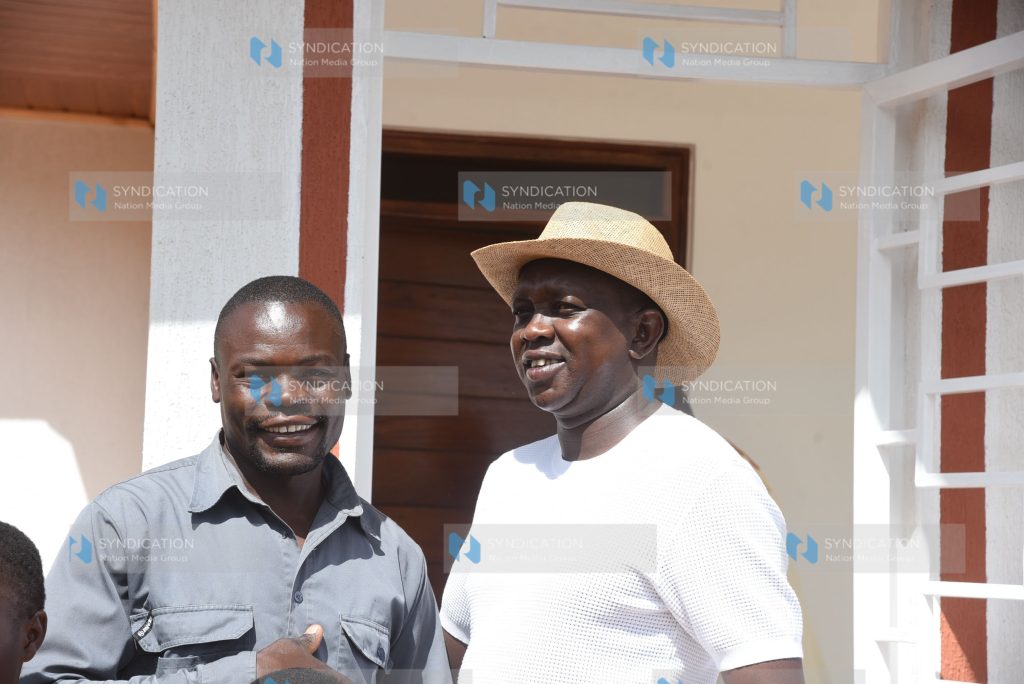 Kapseret MP Oscar Sudi (right) hands over a three-bedroom house to his employee