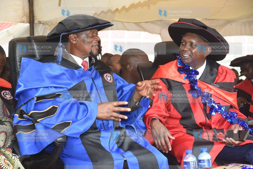 Kapseret MP Oscar Sudi (right) and Sirisia MP John Waluke after receiving honorary degrees