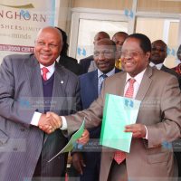 Embu Governor Martin Wambora (right), together with Longhorn Publishers Chairman FT Nyamu