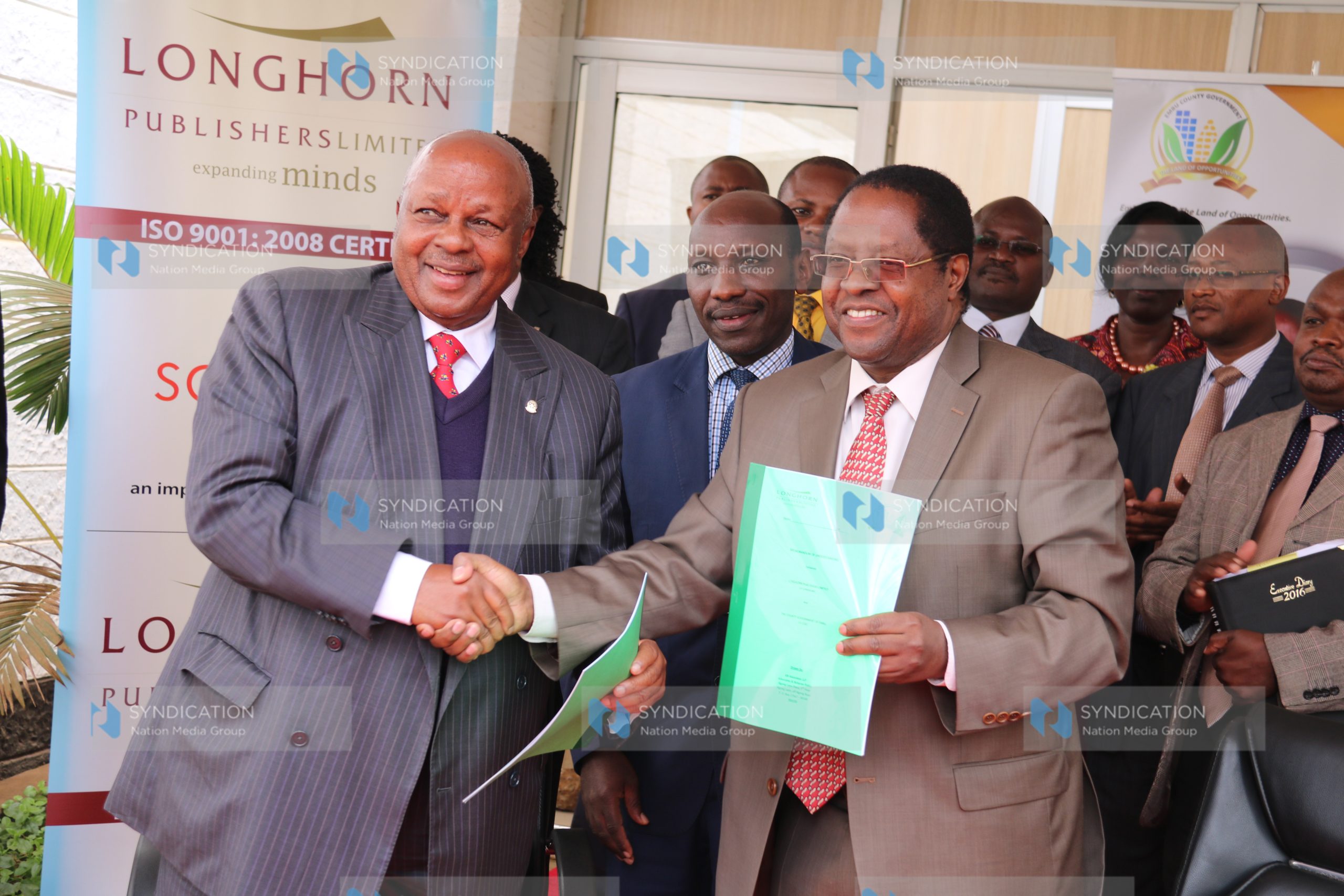Embu Governor Martin Wambora (right), together with Longhorn Publishers Chairman FT Nyamu