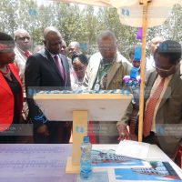 Deputy President William Ruto (second left) looks at the architectural drawing of a dormitory to be built