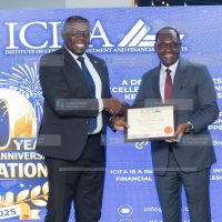 Nation Media Group (NMG) Group Managing Director and CEO Geoffrey Odundo receives an Institute of Certified Investment and Financial Analysts (ICIFA) fellowship certificate from National Treasury Principal Secretary Dr. Chris Kiptoo