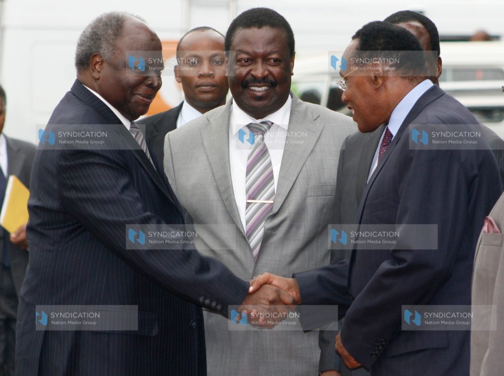 President Mwai Kibaki is received by Deputy Prime Minister and Minister for Local Government Musalia Mudavadi and Internal Security Minister George Saitoti