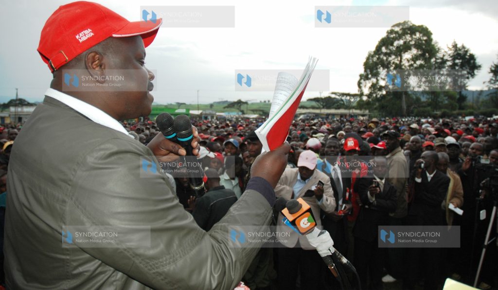 Chepalungu MP Isaac Ruto reads a clause on land from the draft constitution