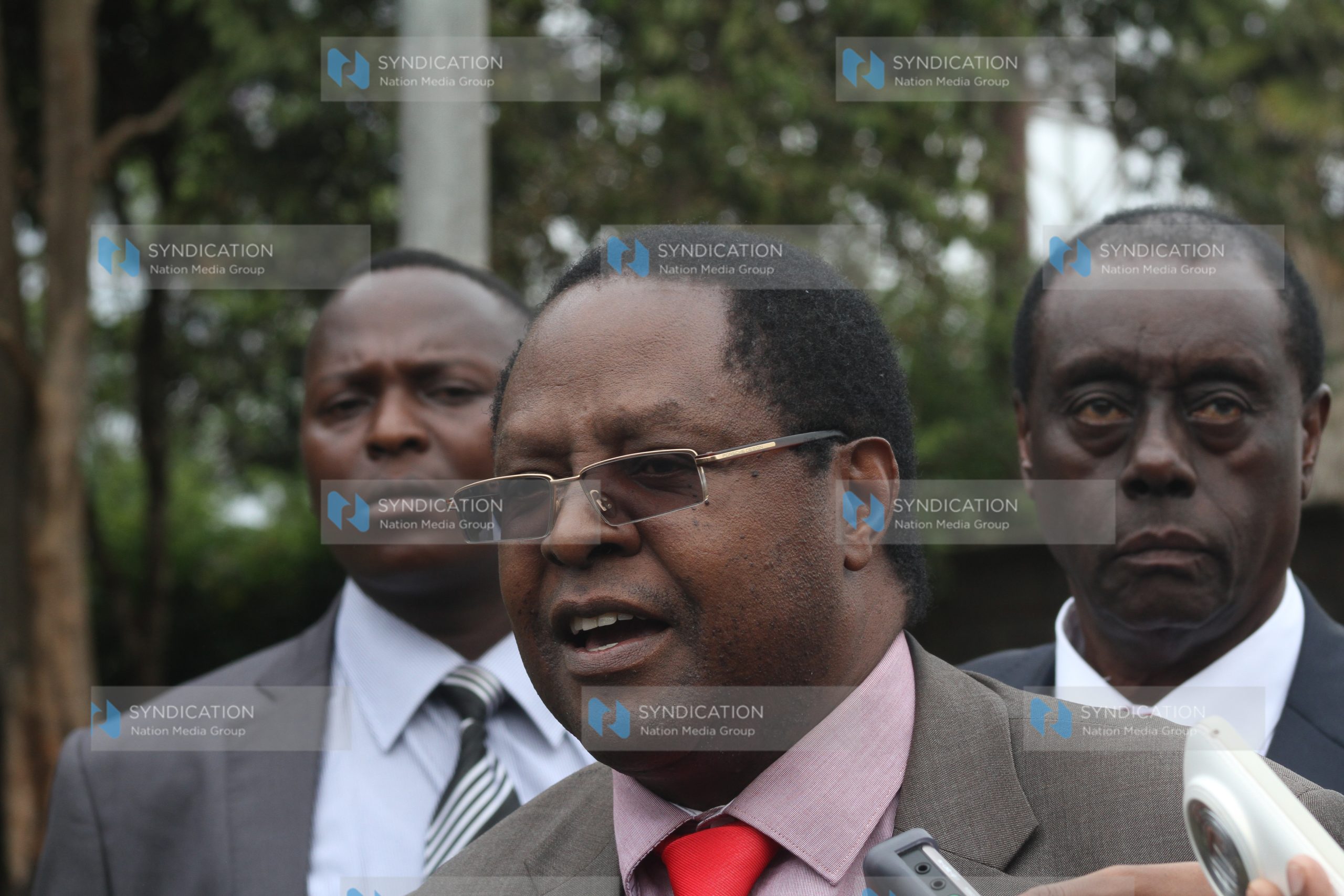 Embu Governor Martin Wambora, flanked by his lawyer Paul Muite (right), addresses the media