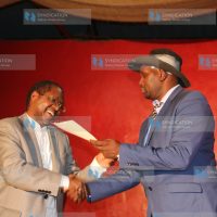 Governor Martin Wambora is handed his interim certificate by Embu County Jubilee Party Returning Officer Kenneth Kamenchu
