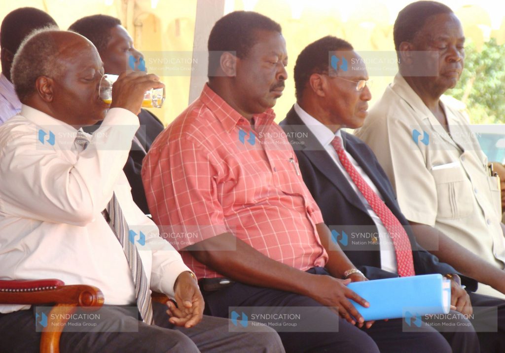 President Mwai Kibaki takes a drink during a public rally