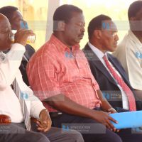 President Mwai Kibaki takes a drink during a public rally