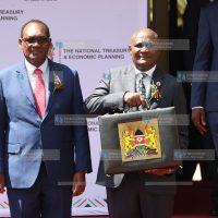 John Mbadi together with PS Chris Kiptoo displays the Budget briefcase
