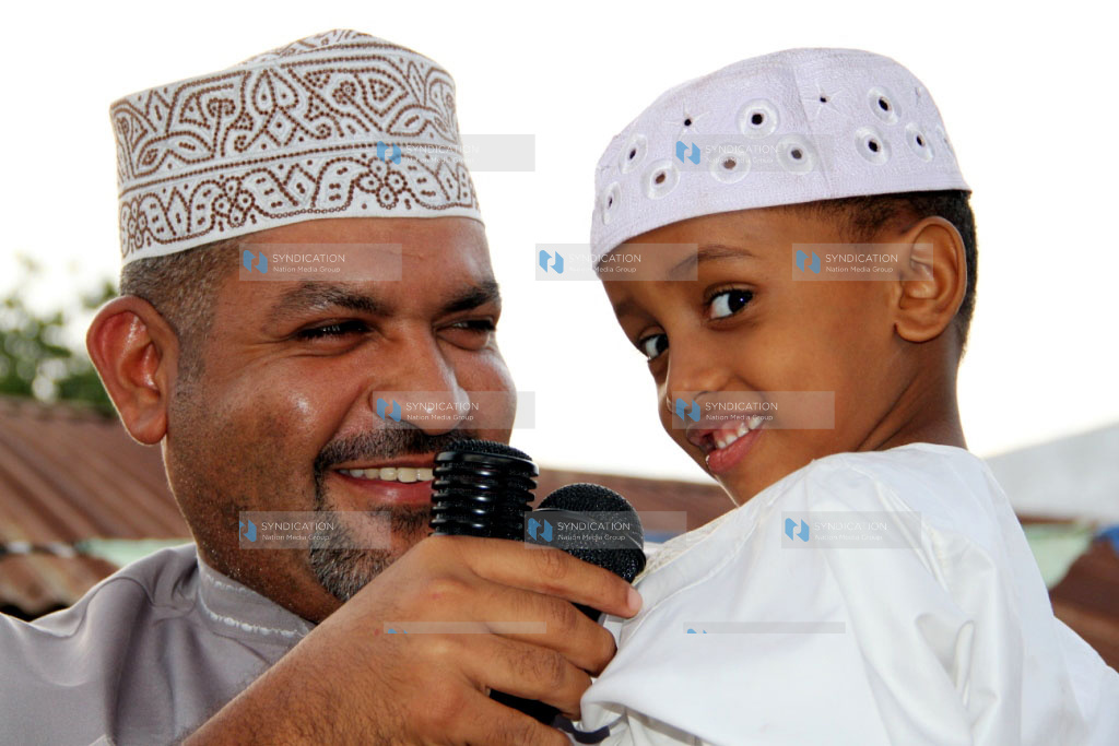 Said Swaleh (right), from Madrassatul Khushui in Mkomani, Kisauni District, is congratulated after emerging as the top pupil