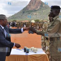 The best recruit in drill and turnout receives an award from KAA chairman Martin Wambora