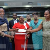 Women Enterprise Fund Advisory Board chairperson, Mumina Bonaya (left) present a cheque of Kshs.500,000/=