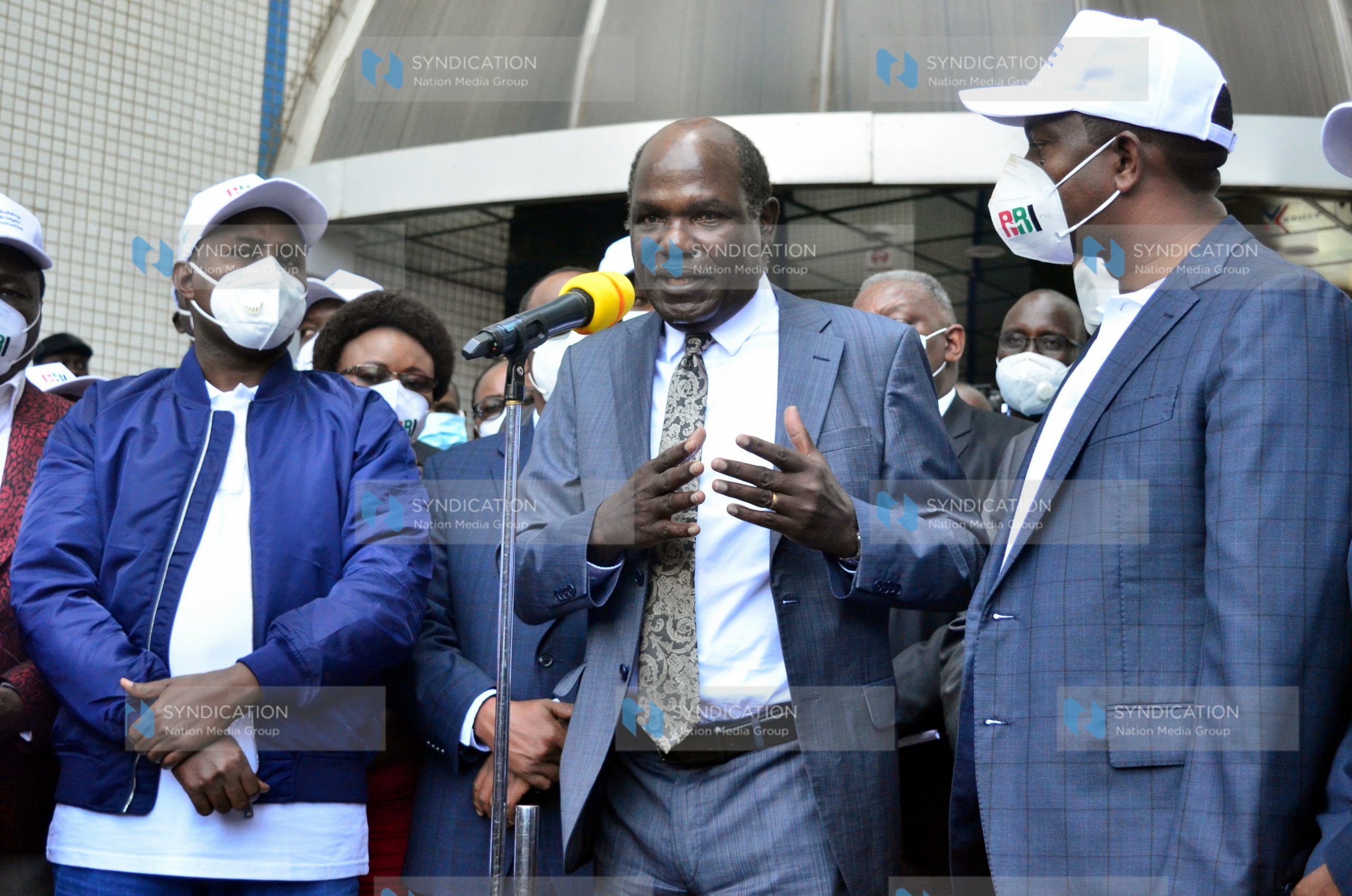 (IEBC) Chairman Wafula Chebukati (center) makes his remarks