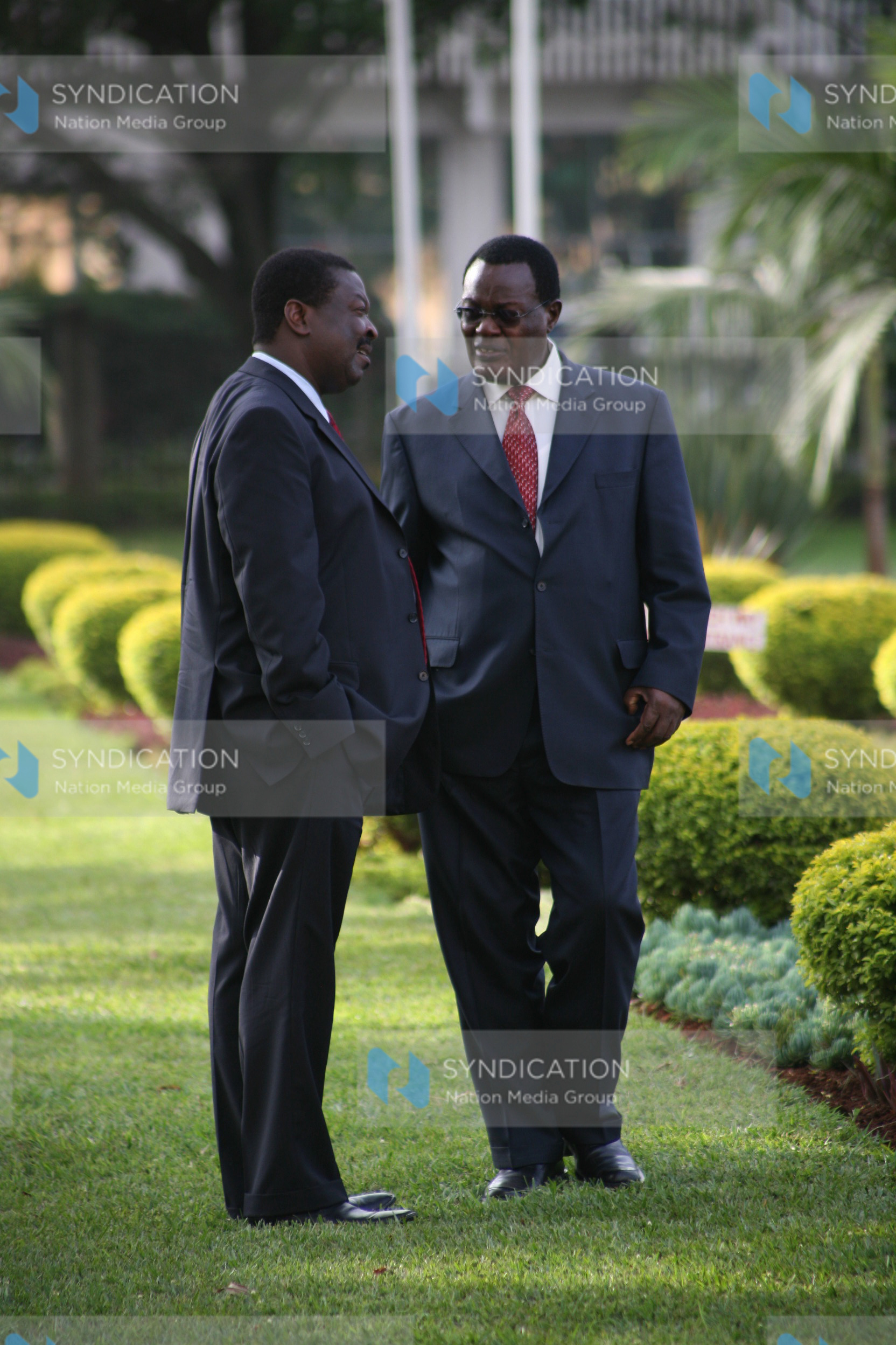 Former finance Minister Musalia Mudavadi (left) and Chris Obure chat