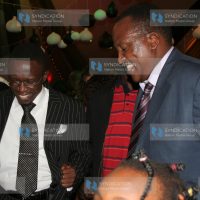 Ababu Namwamba, left, and Richard Onyonka dance during a party