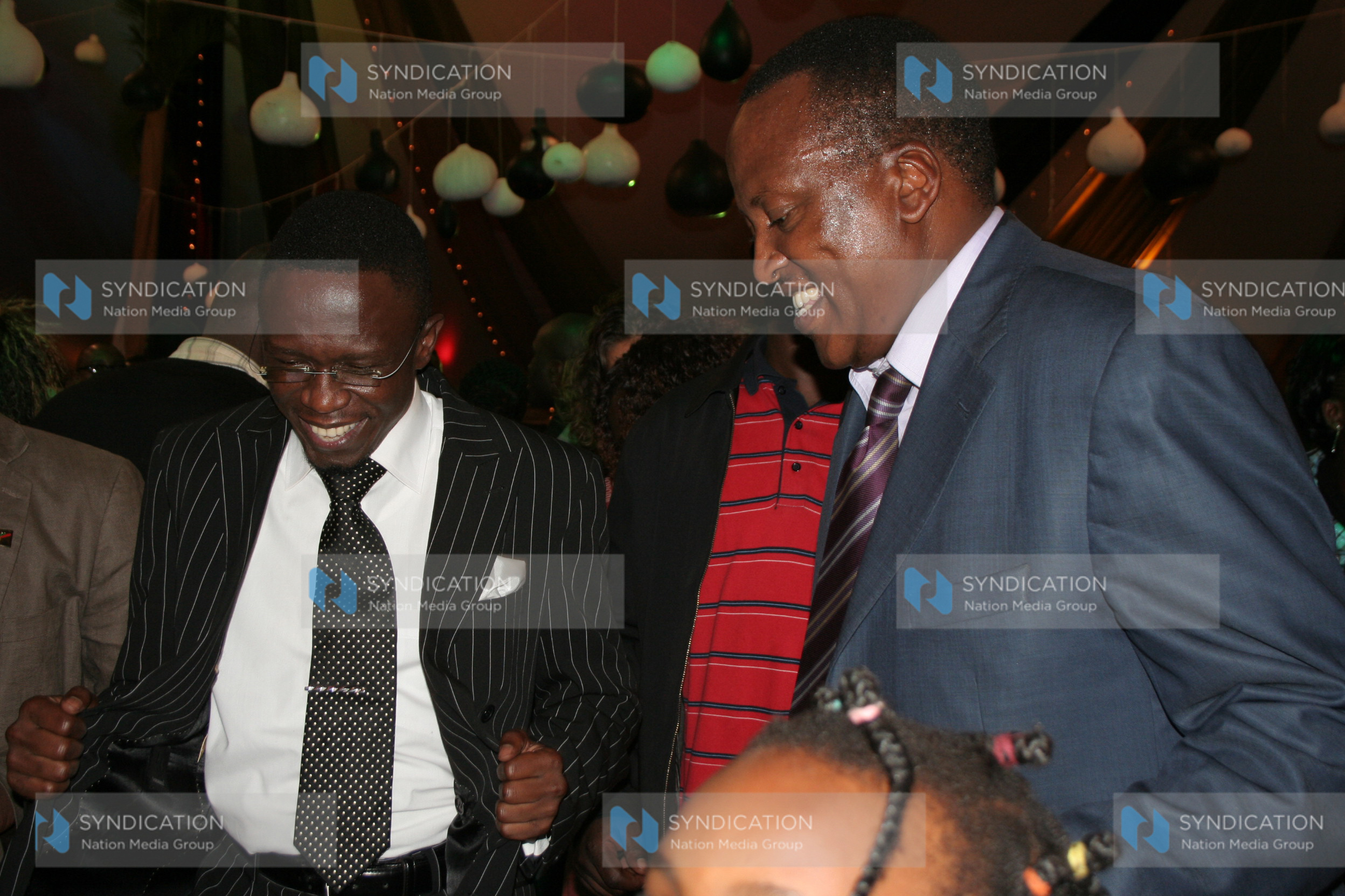 Ababu Namwamba, left, and Richard Onyonka dance during a party
