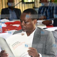 Former Embu Senator Lenny Kivuti reading the BBI report