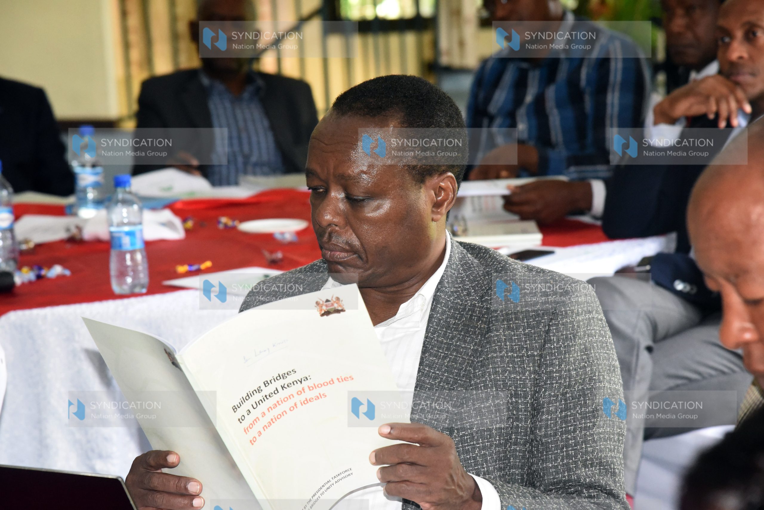 Former Embu Senator Lenny Kivuti reading the BBI report