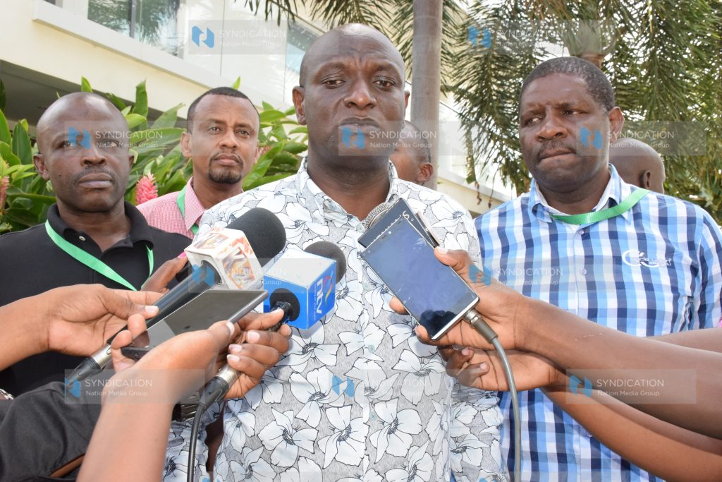 Energy Cabinet Secretary Charles Keter (C) addresses the media