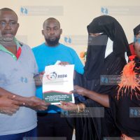 Senator Mithika Linturi receives a report by Human Rights Agenda officials