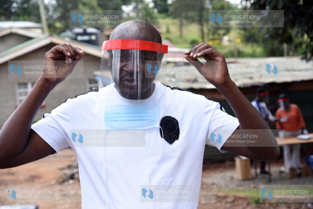 Waithaka MCA Anthony Karanja puts on locally made Personal Protective Equipment (PPE)