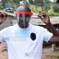 Waithaka MCA Anthony Karanja puts on locally made Personal Protective Equipment (PPE)