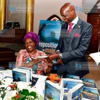 Rev. Canon Dr. Rosemary Mbogo (left) presents an autographed book to Embu County Senator Munyi Alexander Mundigi