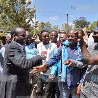 Former Embu Senator Lenny Kivuti greets a group of youths outside the Embu High Court