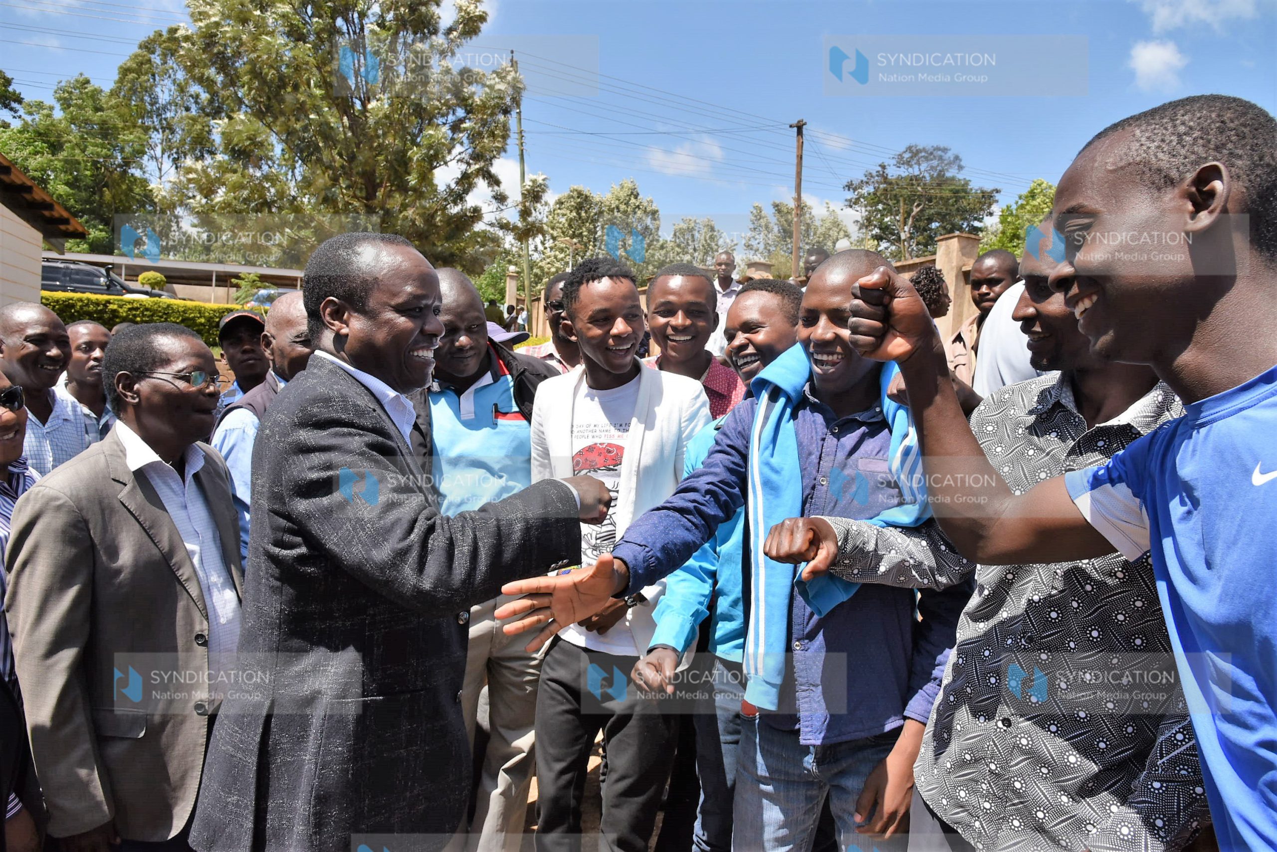 Former Embu Senator Lenny Kivuti greets a group of youths outside the Embu High Court