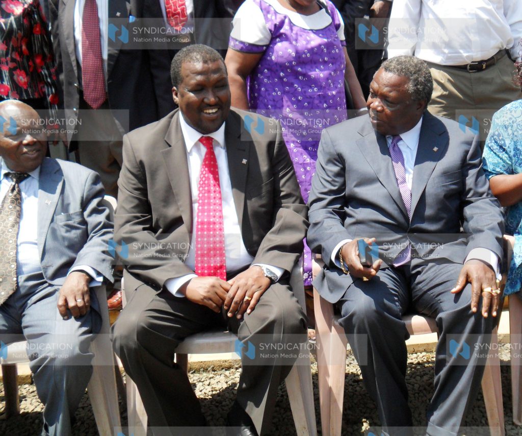 Labor minister John Munyes (left) talks to COTU Secretary General Francis Atwoli (right) during a workshop for trade unionists