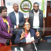 (Center) Nairobi Speaker Beatrice Elachi speaking to the press surrounded by her supporters