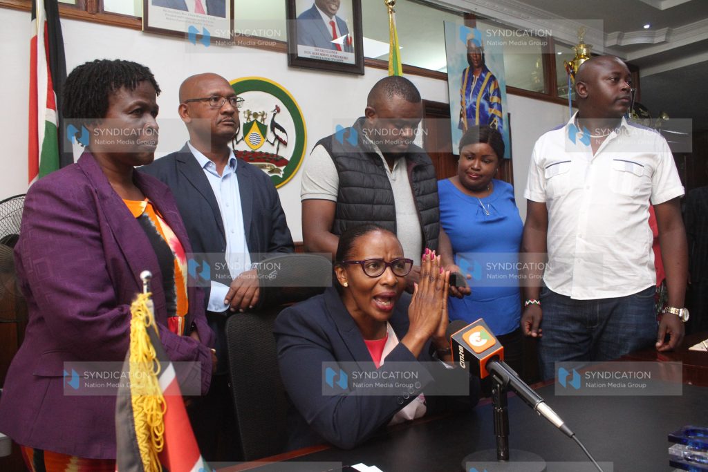 (Center) Nairobi Speaker Beatrice Elachi speaking to the press surrounded by her supporters