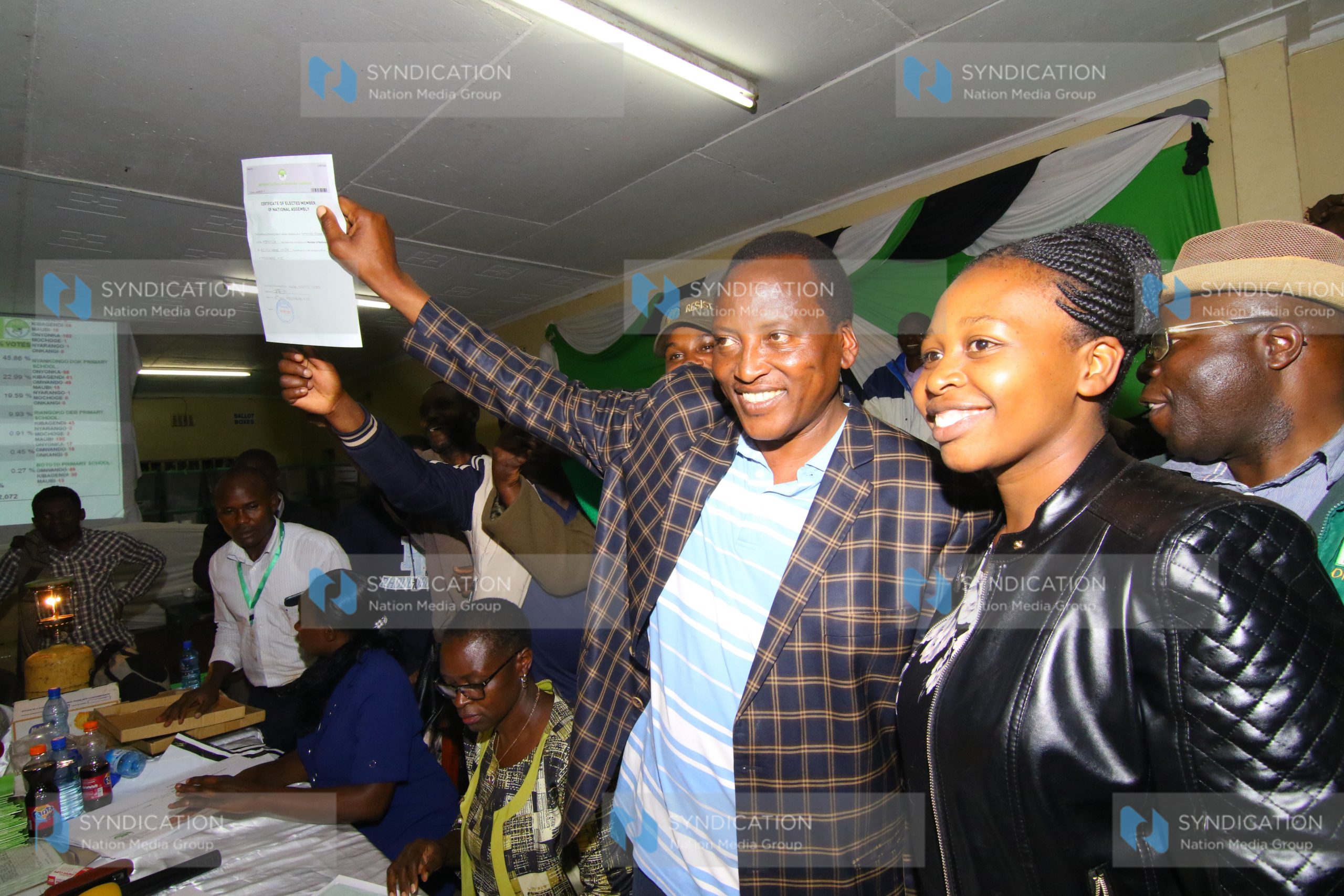 Ford Kenya party candidate and MP-elect Richard Onyonka and his wife Gesare Onyonka (in black jacket) display his winning certificate