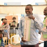 Julius Mawathe displays a ballot paper before casting his vote