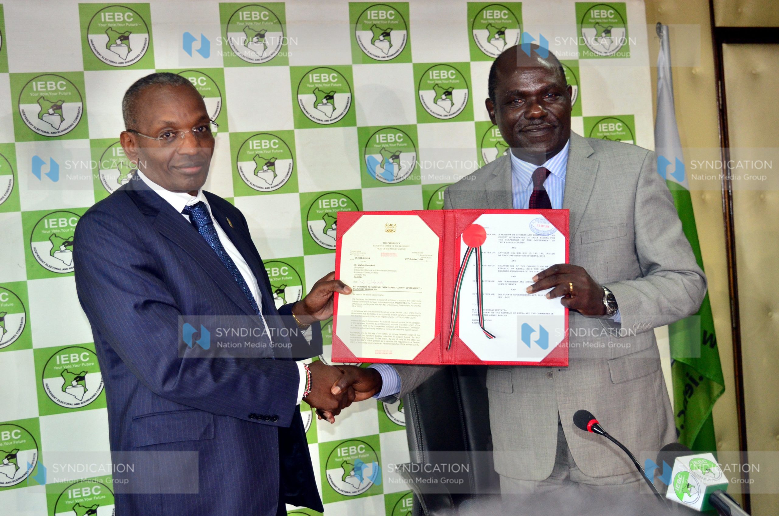 Executive Office of the President, Principal Administrative Secretary Kennedy Kihara presents a petition to IEBC Chairman Wafula Chebukati