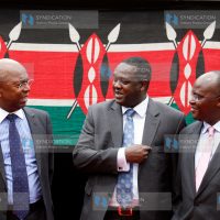 Safaricom Chief Executive Officer Bob Collymore chats with Sports and Culture Cabinet Secretary Hassan Wario and his Health colleague James Macharia