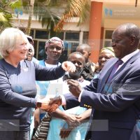 The Canadian Nurses for Africa president Patti Harbman presenting motorbike keys to Vihiga governor Wilber Ottichilo