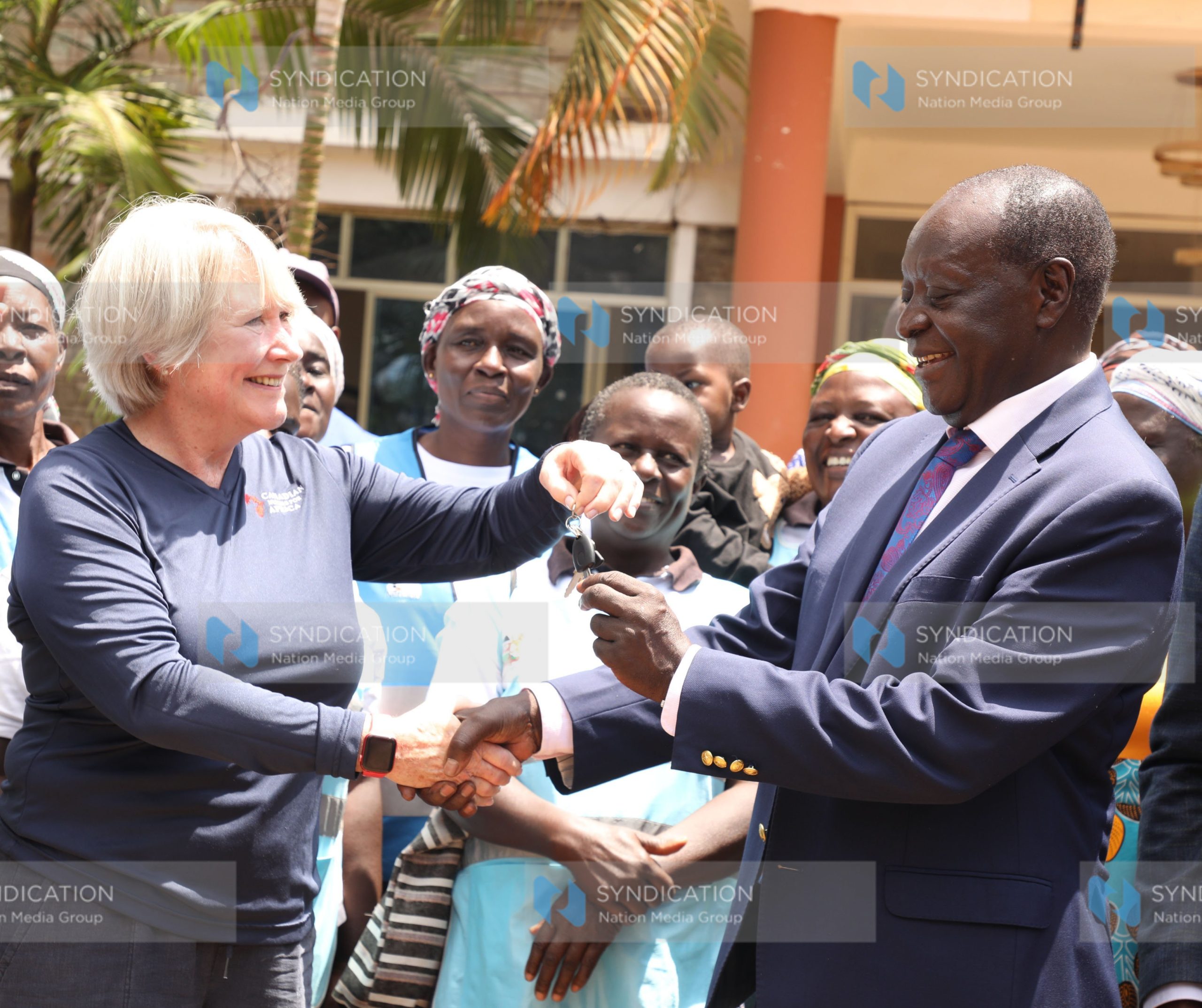 The Canadian Nurses for Africa president Patti Harbman presenting motorbike keys to Vihiga governor Wilber Ottichilo