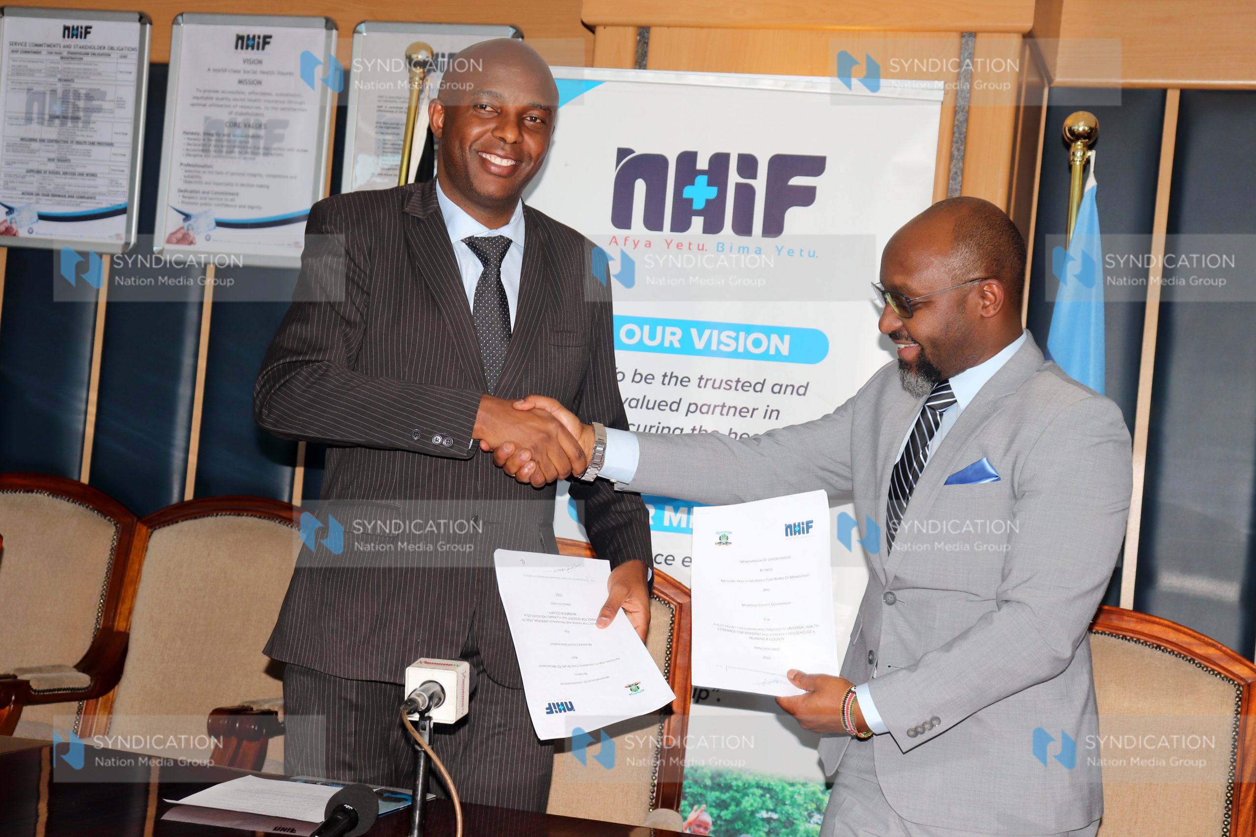 National Hospital Insurance Fund (NHIF) CEO Dr. Peter Kamunyo with Murang’a County Governor Irungu Kang’ata