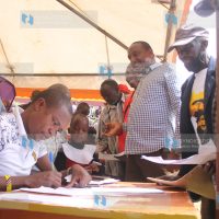 Molo MP Kuria Kimani assists parents in filling the students’ bursary forms