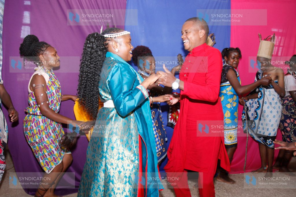 Molo MP Kuria Kimani and his wife Winnie Mumbi with students