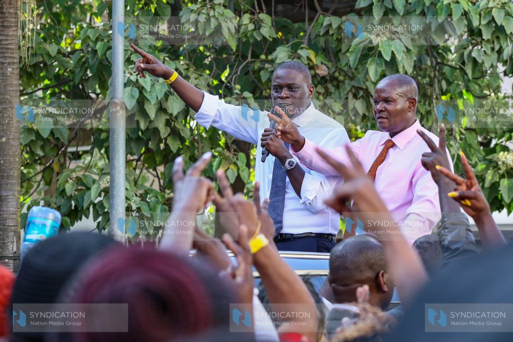 Nairobi City County Governor Johnson Sakaja (left), flanked by County Assembly Speaker Kennedy Ng’ondi, addresses supporter