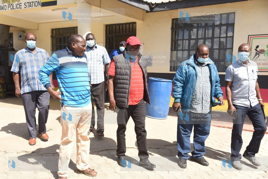 Meru Senator Mithika Linturi is escorted into a police vehicle