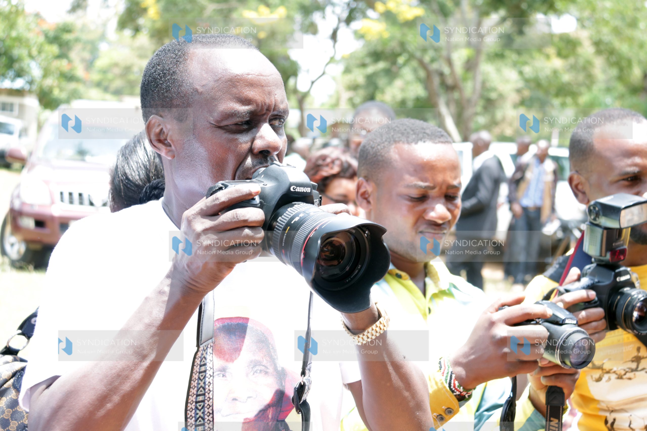Embu Senator Lenny Kivuti takes photographs during the requiem Mass for his 117-year-old grandmother