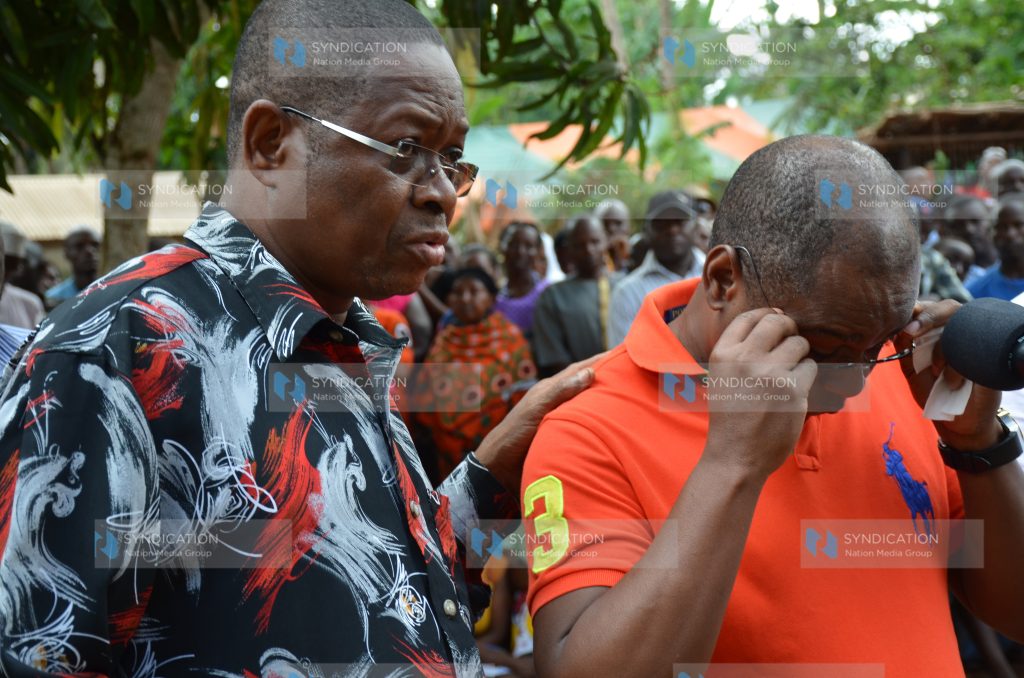 Kilifi Senator Stewart Madzayo (left) consoles Governor Amason Kingi (right) after he broke down in tears as he addressed mourners